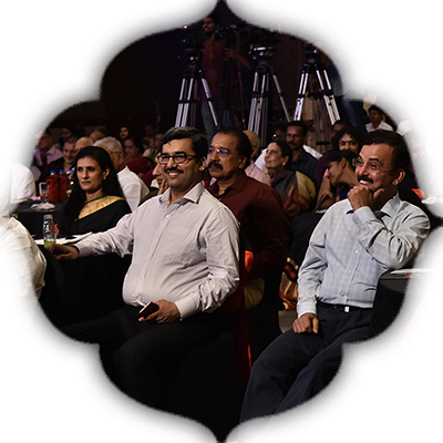 Chief Electoral Officer Rajesh Lakhoni enjoying a light moment with others in the audience at the 13th edition of Devi Awards