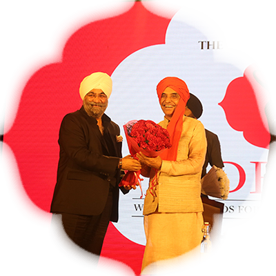 Raju Chadha, Chairman, Wave Group, presents a bouquet to the minister
