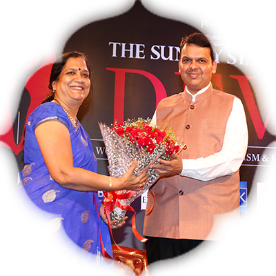 Dr Manjusha Molwane, Member Secretary, Maharashtra State Commission for Women, presents a bouquet to the CM
