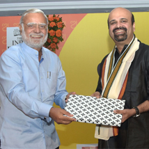 Editorial Director of The New Indian Express felicitating pianist Anil Srinivasan (R)