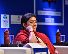 Union Minister Smriti Irani smiles at a remark made during the panel discussion.