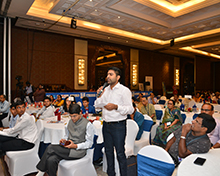 An audience member asks a question during the interaction with the panelists.